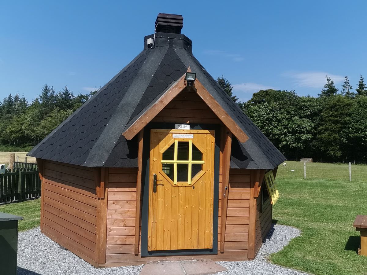 The timber barbecue hut beside the lawn