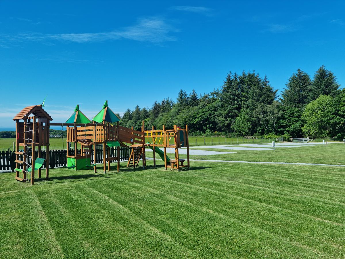 The wooden climbing frame play area