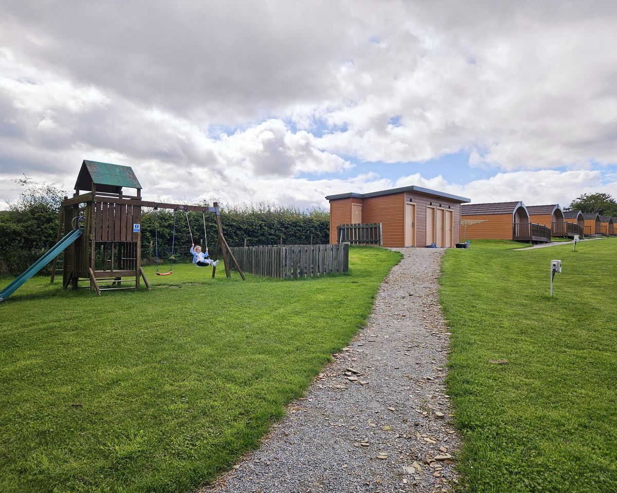 The play area, the shower block and the path to the pods at Greencraig