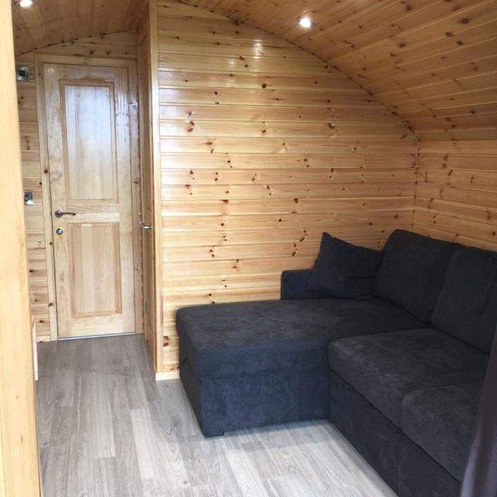 The sofa bed and pine-clad living space inside a pod